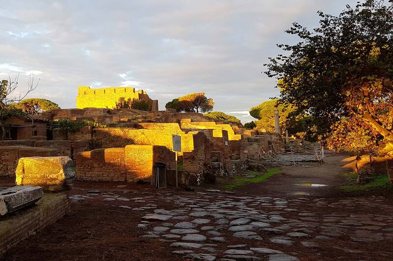 Ruins along the Decumanus Maximus with Capitolium in the background at sunset